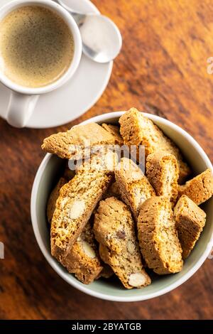 Sweet italian cantuccini cookies. Almonds biscuits with coffee cup on wooden table. Top view. Stock Photo