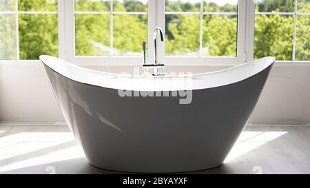 Modern bathroom in bright interior with big window and sunny light Stock Photo