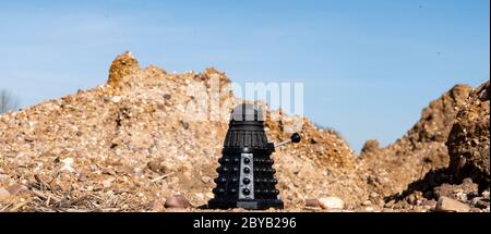 Black Dalek in a barren landscape Stock Photo