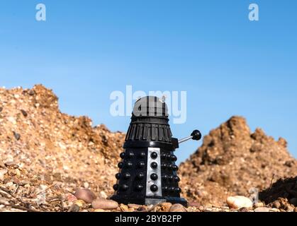 Black Dalek in a barren landscape Stock Photo