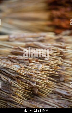 Portions of raw meat, vegetables and seafood on wooden sticks, ready to be grilled on the street in the Muslim Quarter, Xian town, China Stock Photo