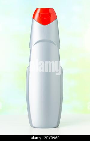 Nameless gray plastic bottle with red cap of detergent on a colored background Stock Photo