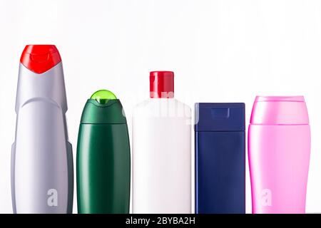 A lot of nameless plastic bottles of different colors from under a cosmetic product on a white background Stock Photo