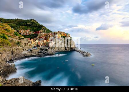 View of Manarola village at sunset. Manarola is one of famous villages of the Cinque Terre - a beautiful coastal area on the north of Italy. Italy Stock Photo