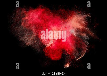 Colorful dust particle explosion resembling blood or a pyrotechnic effect over black. Abstract background. Closeup a color explosion isolated on black Stock Photo