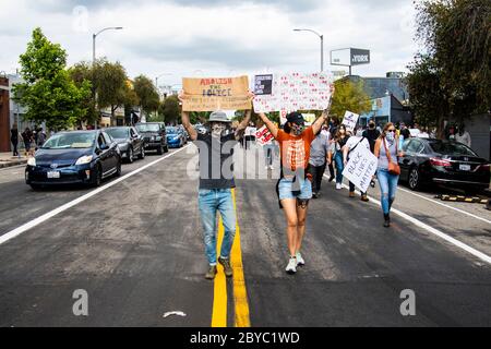 Protestors carry signs during peaceful protest in Los Angeles honoring George Floyd Stock Photo