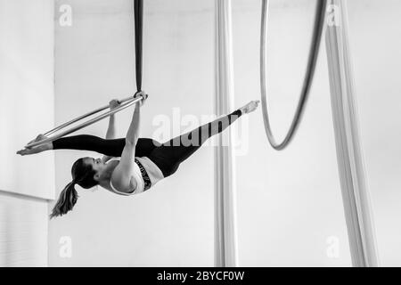 A Colombian aerial dancer performs on aerial hoop during a training session in a gym in Medellín, Colombia. Stock Photo