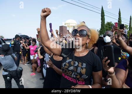 Demonstrators along the route of George Floyd's funeral procession pay their respects with raised fists and anti-police brutality chants. The death of Floyd, who was killed by a white policeman in late May, set off protests worldwide against racism and police brutality. Stock Photo