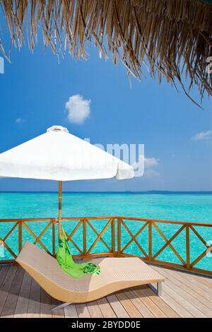 chaise lounge on a terrace of water villa, Maldive Stock Photo