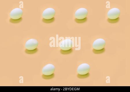 Abstract eggs arranged on solid color background Stock Photo