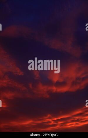 dramatic sky with orange clouds after sunset Stock Photo