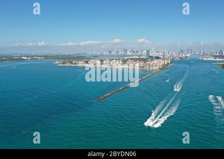 Aerial view of Fisher Island, South Pointe and Government Cut with City of Miami skyline and Port Miami in background. Stock Photo