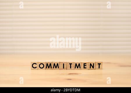 Commitment, word text typography written on wooden alphabet letterpress cubes Stock Photo