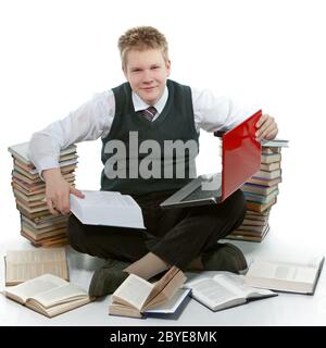 The teenager with a heap of textbooks. Stock Photo