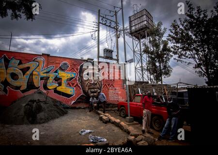 Nairobi, Kenya. 09th June, 2020. Residents of Kibera are seen working infront of George Floyds Mural amid coronavirus pandemic.Residents of Nairobi have decided to move on with their business as usual despite the economy lockdown and restrictions of movements in and out of the Country including restrictions of movements outside Nairobi, Mombasa and other Counties. Credit: SOPA Images Limited/Alamy Live News Stock Photo