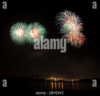 Double Green Fireworks at lake on King Birthday Festival and Holiday in Thailand. Stock Photo