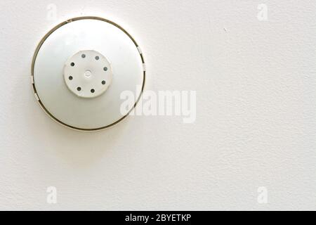 Smoke and heat alarm detecter isolated on white ceiling Stock Photo