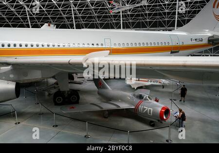 An Airbus A300B wide body airliner with a Soviet MiG-15 jet fighter display in Musee Aeroscopia Museum. Blagnac.Toulouse.Haute-Garonne.Occitanie.France