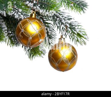 yellow New Year's balls and snow-covered branches Stock Photo