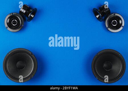 Car audio, car speakers, black subwoofer on a blue background. Copy space Stock Photo