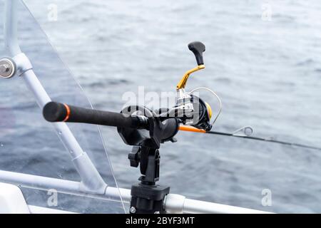 Fishing rod spinning with the line close-up. Fishing rod in rod holder