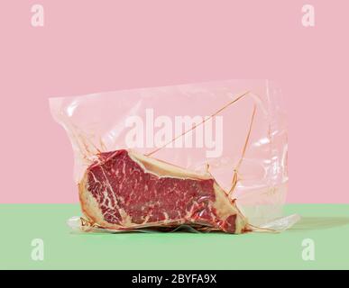 raw steak in cellophane sous vide packaging on a colored background Stock Photo