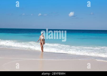 woman in the New Year's cap walks on a beach Stock Photo