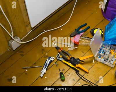 Electrician tools scattered in a mess on the floor, indoor shot Stock Photo