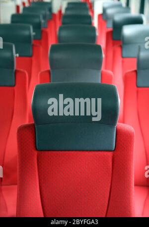 rows of red seats in train Stock Photo