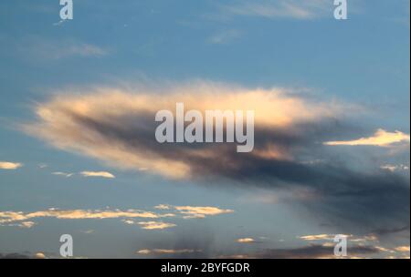 A dark cloud on a blue background Stock Photo
