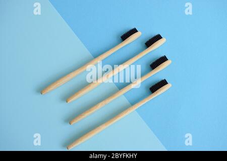 Flat lay composition with bamboo toothbrushes on lightblue and blue background Stock Photo