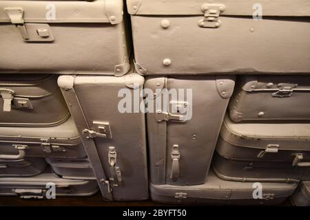 Retro style abstract background made from parts of vintage leather suitcases painted in beige color Stock Photo
