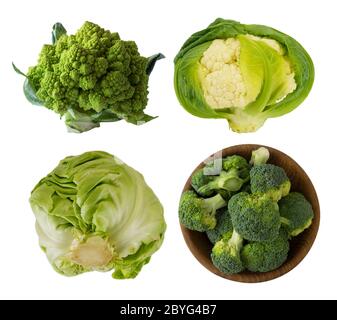 Different kinds of cabbage in a wooden bowl. Broccoli, Brussels sprouts, Roman cauliflower, green cabbage isolated on white background. Сabbage with c Stock Photo