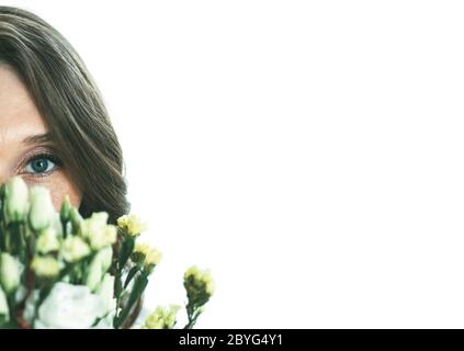 Portrait of a young woman in flowers on a white isolated background Stock Photo