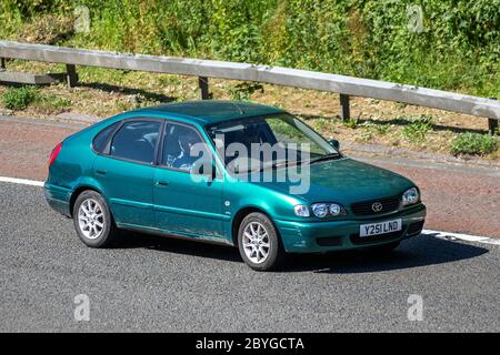 2001 green Toyota Corolla VVTI GS; Vehicular traffic moving vehicles, cars driving vehicle on UK roads, motors, motoring on the M6 motorway Stock Photo