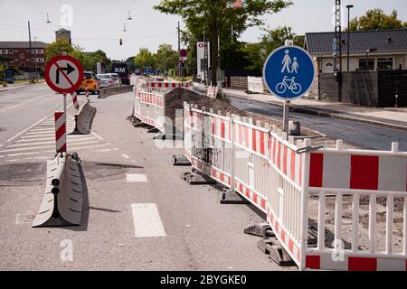 Road signs and roadworks partially blocking a road. Do not turn right and pedestrians and bicycle only signs. Copenhagen, Denmark - June 9, 2020. Stock Photo