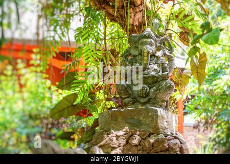 Stone hindu god Ganesha statue in asian hotel resort. Bali, Indonesia Stock Photo