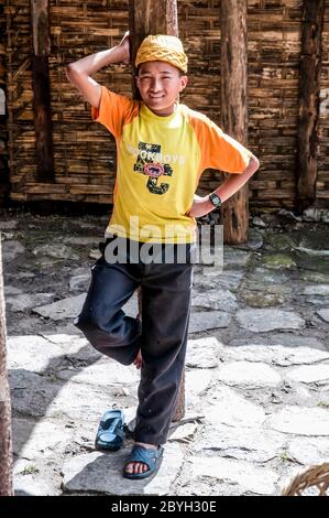 Nepal. Island Peak Trek. A young lad takes a break at the village of Phakding on his way to the trading town of Namche Bazaar Stock Photo