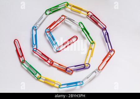Paperclip chain spiral, Paperclips chain spiral, isolated on white background - paper clips, paper clip abstract Stock Photo