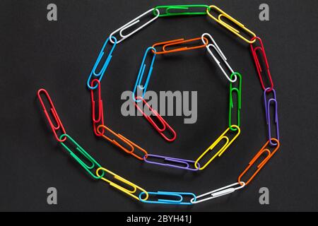 Paperclip chain spiral, Paperclips chain spiral, isolated on black background - paper clips, paper clip abstract Stock Photo