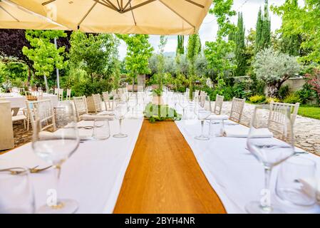 Italy. Table of an outdoor restaurant ready to welcome customers. Catering and banqueting. Stock Photo
