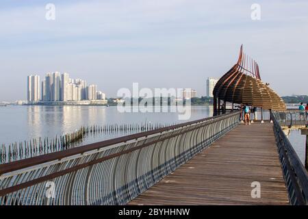 The observation point next to kingfisher pond in the Sungei Buloh wetland reserve Singapore. The background is the buildings of JOHOR BAHRU Malaysia. Stock Photo