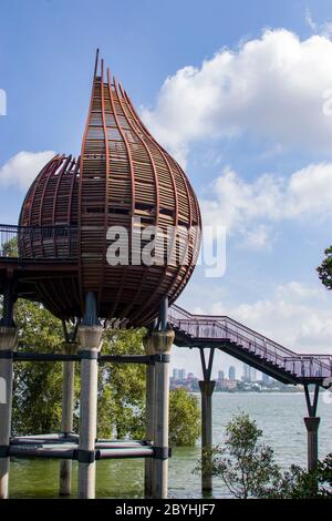 The observation point next to kingfisher pond in the Sungei Buloh wetland reserve Singapore. The background is the buildings of JOHOR BAHRU Malaysia. Stock Photo