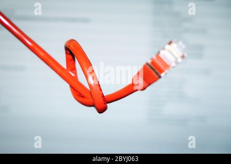 red networking cable with a knot Stock Photo