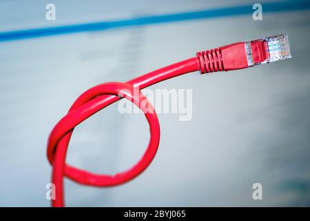 red networking cable with a knot Stock Photo