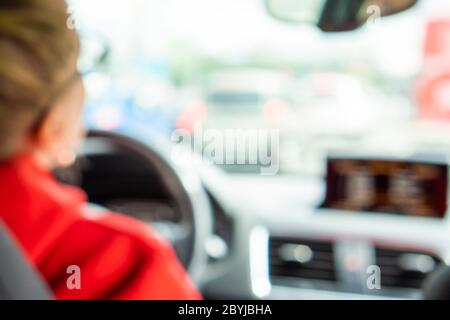 woman driving a car, blurred background image Stock Photo