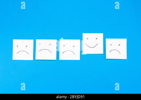 Many stickers - negative and positive emoticon on a blue background Stock Photo