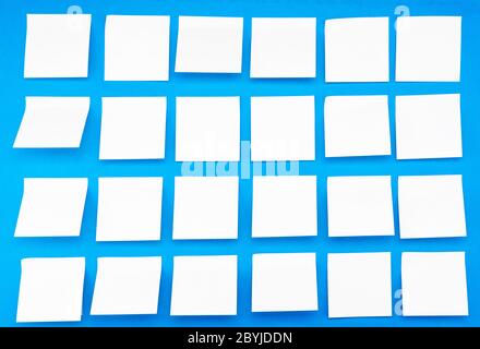 A lot of blank yellow stickers on a blue background. Side view Stock Photo