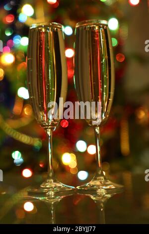 glasses with champagne against festive lights Stock Photo