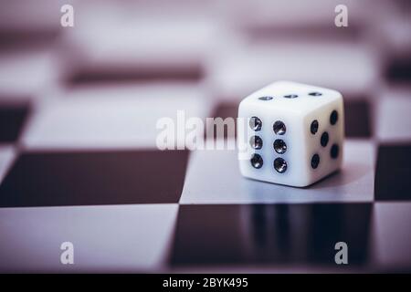 Dice on table, vintage effect. Background for casino games, gambling, luck or randomness. Rolling the dice concept for business risk, chance, good luc Stock Photo